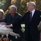 Unindicted co-conspirator and President of the United States, Donald Trump, touches a turkey on November 20, 2018 before heading to his private resort in Florida